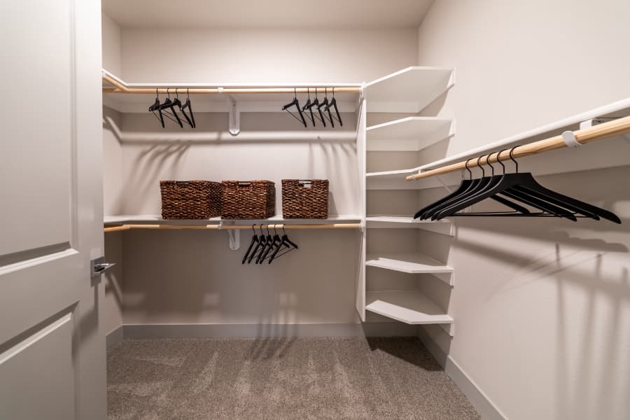 Large closet in an apartment with shelves and hangers